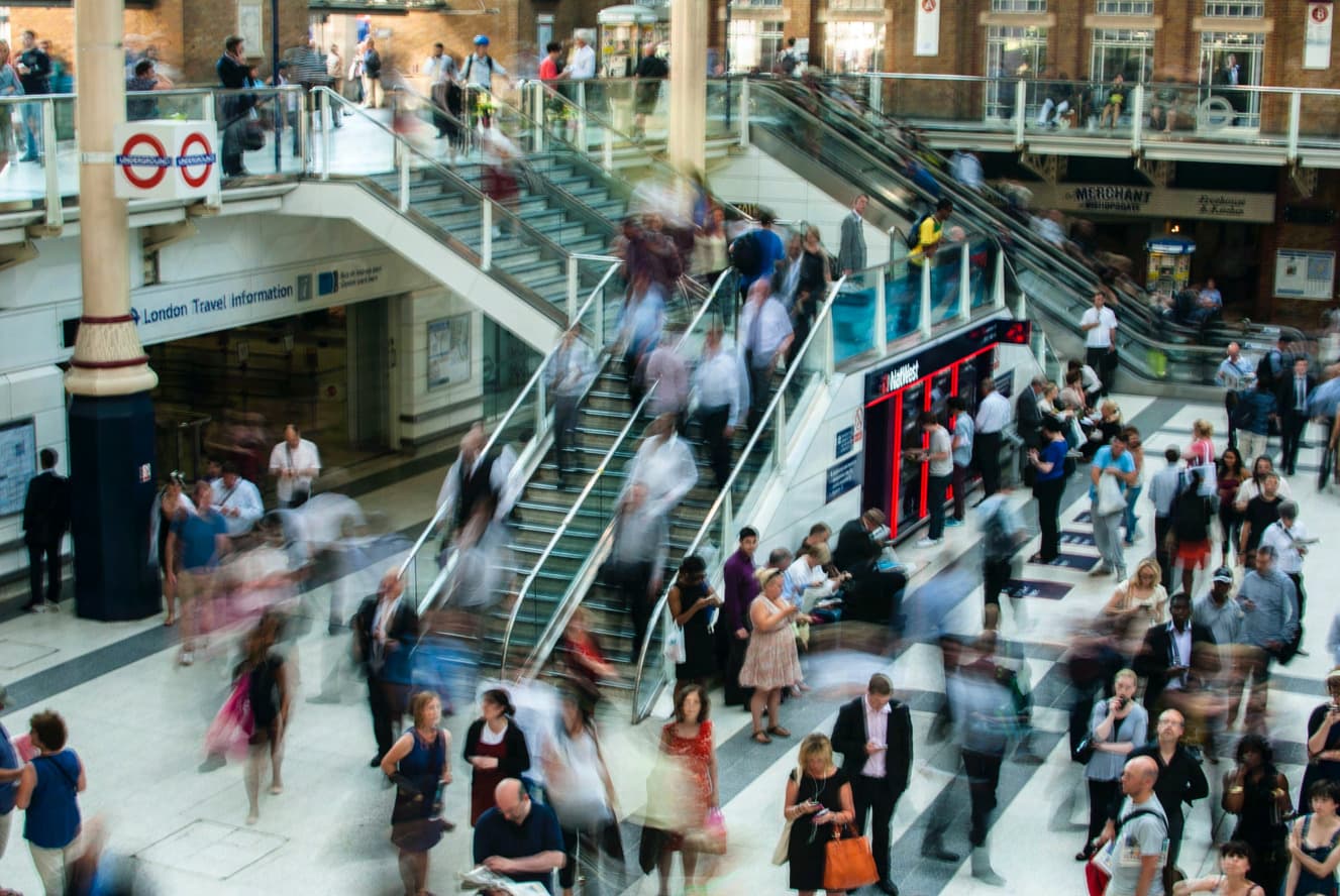 Crowd in a public transit hub representing population-scale surveillance